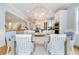 Elegant dining area with a modern chandelier, stylish chairs, and a view into the kitchen at 3204 Waterway Blvd, Isle of Palms, SC 29451