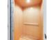 Home elevator with light wood paneled walls and hardwood floor at 3204 Waterway Blvd, Isle of Palms, SC 29451