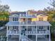 Beautiful exterior shot of a two-story home with multiple balconies and ample curb appeal at 3204 Waterway Blvd, Isle of Palms, SC 29451