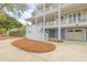 Charming three-story home boasts a welcoming facade, multiple balconies, and a spacious driveway at 3204 Waterway Blvd, Isle of Palms, SC 29451