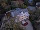 Aerial view of a lovely three-story home surrounded by tall trees giving lots of privacy to the owners at 3204 Waterway Blvd, Isle of Palms, SC 29451