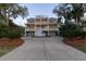 Large home boasts multiple decks and a sprawling driveway surrounded by trees at 3204 Waterway Blvd, Isle of Palms, SC 29451