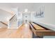 Spacious hallway with hardwood floors, staircase, and a shuffleboard table for entertainment at 3204 Waterway Blvd, Isle of Palms, SC 29451