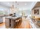 Open-concept kitchen with granite countertops, a center island with seating, and stainless steel appliances at 3204 Waterway Blvd, Isle of Palms, SC 29451