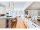 Bright, open kitchen featuring a marble-topped island with barstool seating and modern pendant lighting at 3204 Waterway Blvd, Isle of Palms, SC 29451