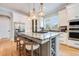 Open kitchen with a large central island, pendant lighting, wine rack, and stainless steel appliances at 3204 Waterway Blvd, Isle of Palms, SC 29451