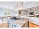 Bright, modern kitchen with a large center island with gas range and views into the dining and living areas at 3204 Waterway Blvd, Isle of Palms, SC 29451