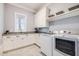 Well-organized laundry room with modern washer and dryer, ample counter space, and natural light at 3204 Waterway Blvd, Isle of Palms, SC 29451