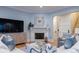 Inviting living room with fireplace, light blue walls and modern decor at 3204 Waterway Blvd, Isle of Palms, SC 29451