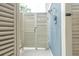 Private outdoor shower featuring enclosed wooden doors with mounted shower-head and temperature control at 3204 Waterway Blvd, Isle of Palms, SC 29451