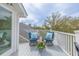 Relaxing outdoor patio with comfortable seating, a table, and scenic views of the surrounding trees at 3204 Waterway Blvd, Isle of Palms, SC 29451