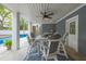 Covered patio with outdoor dining area, ceiling fan, and view of the sparkling pool at 3204 Waterway Blvd, Isle of Palms, SC 29451