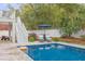 Backyard pool featuring a lounge area and white picket fence, ideal for relaxation and privacy at 3204 Waterway Blvd, Isle of Palms, SC 29451