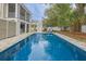 Sparkling pool surrounded by a stone patio and lush landscaping, perfect for outdoor relaxation at 3204 Waterway Blvd, Isle of Palms, SC 29451