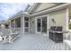 A screened-in porch with gray Adirondack chairs and a gas grill at 3204 Waterway Blvd, Isle of Palms, SC 29451