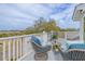 A beautiful deck features luxury cushioned chairs and a serene view at 3204 Waterway Blvd, Isle of Palms, SC 29451