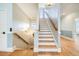 Elegant staircase with hardwood steps, white risers, and modern lighting fixtures at 3204 Waterway Blvd, Isle of Palms, SC 29451