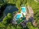 Aerial view of multiple pools near a lake and parking surrounded by lush greenery at 3425 Oxfordshire Ln, Mount Pleasant, SC 29466