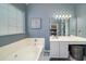Elegant bathroom with soaking tub, vanity, and decorative wall art at 3425 Oxfordshire Ln, Mount Pleasant, SC 29466