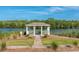 Scenic view of gazebo overlooking a pond surrounded by lush greenery and landscaping at 3425 Oxfordshire Ln, Mount Pleasant, SC 29466