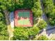Aerial view of well-maintained tennis courts surrounded by lush greenery and trees at 3425 Oxfordshire Ln, Mount Pleasant, SC 29466