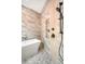 Bathroom features marble tiling, a soaking tub, a rainfall shower head, and built-in shelving niche at 40 Pitt St, Charleston, SC 29401