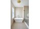 Serene bathroom featuring soaking tub and glass shower at 40 Pitt St, Charleston, SC 29401