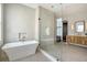 Bright, modern bathroom with soaking tub and glass shower at 40 Pitt St, Charleston, SC 29401