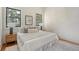 Bright bedroom featuring neutral walls, a stylish rug, large windows, and hardwood floors at 40 Pitt St, Charleston, SC 29401