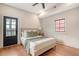 Bright bedroom featuring hardwood floors, a door to the exterior, and a ceiling fan at 40 Pitt St, Charleston, SC 29401