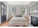 Bedroom with hardwood floors, fireplace and views to the outside at 40 Pitt St, Charleston, SC 29401