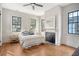 Cozy bedroom with hardwood floors, fireplace, ceiling fan, and plenty of natural light at 40 Pitt St, Charleston, SC 29401