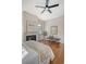 Bedroom featuring a decorative fireplace, bench, ceiling fan and hardwood floors at 40 Pitt St, Charleston, SC 29401