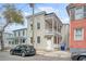 Two-story home with inviting double porches, neutral siding, and traditional details in an urban setting at 40 Pitt St, Charleston, SC 29401