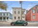 Classic two-story home with inviting double porches, neutral siding, and traditional details in a bustling city area at 40 Pitt St, Charleston, SC 29401