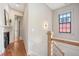 Hallway featuring a traditional fireplace, hardwood floors, and view to a room with great natural light at 40 Pitt St, Charleston, SC 29401