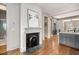 Transitional hallway features hardwood floors, a fireplace, and an open view into an adjacent kitchen area at 40 Pitt St, Charleston, SC 29401