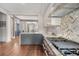 Beautiful kitchen with a herringbone backsplash, stainless appliances and a view to the living room at 40 Pitt St, Charleston, SC 29401