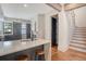 Stylish kitchen features an island with seating, stainless steel appliances, and an adjacent wooden staircase at 40 Pitt St, Charleston, SC 29401