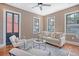 Inviting living room featuring hardwood floors, neutral paint, a decorative fireplace, and bright natural light at 40 Pitt St, Charleston, SC 29401