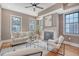 Cozy living room boasting hardwood floors, neutral paint, a decorative fireplace, and natural light from large windows at 40 Pitt St, Charleston, SC 29401