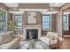 Elegant living room featuring a fireplace, hardwood floors, and large windows for ample sunlight at 40 Pitt St, Charleston, SC 29401