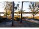 Secluded backyard with mature trees and water views, offering a serene and private outdoor space at 4009 Ballovista Rd, Johns Island, SC 29455