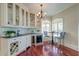 Wet bar area with wine fridge, glass cabinets, and lots of natural light at 4009 Ballovista Rd, Johns Island, SC 29455