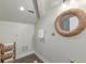 Bright bathroom featuring a round decorative mirror and a woven basket for towel storage at 4009 Ballovista Rd, Johns Island, SC 29455