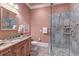 Bathroom featuring pink walls, tiled shower, stylish vanity, and decorative accents at 4009 Ballovista Rd, Johns Island, SC 29455