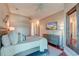 Neutral bedroom with hardwood floors, TV, and decorative mirror at 4009 Ballovista Rd, Johns Island, SC 29455