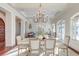 Open dining and living room layout with a chandelier, decorative stone table, and hardwood floors at 4009 Ballovista Rd, Johns Island, SC 29455