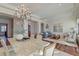 Formal dining room featuring a decorative stone table, chandelier, and hardwood floors at 4009 Ballovista Rd, Johns Island, SC 29455