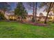 Lush green lawn view showcasing a sprawling residence with classic architecture, mature trees and landscape lighting at 4009 Ballovista Rd, Johns Island, SC 29455